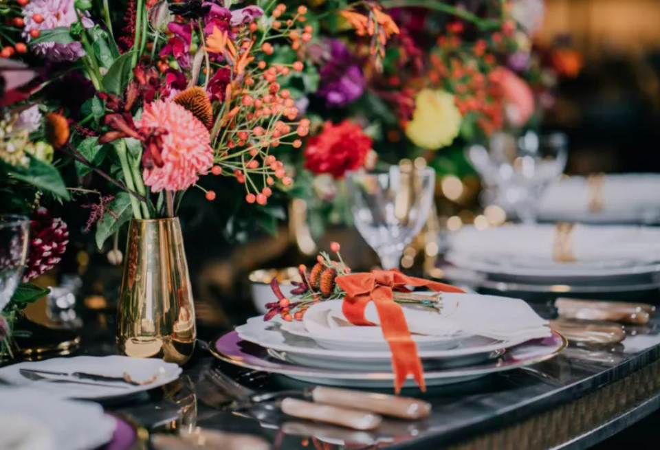 High end formal dining room sets decorated with a bouquet centrepiece on the table.