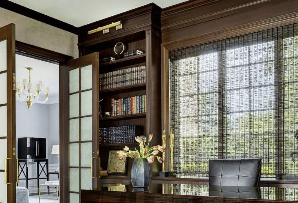 Modern luxury home office desk and bookcase setup.