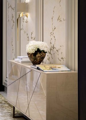 Elegant Hallway that features a sideboard finished in a light sycamore silk with an abstract brushed brass detail - A Serene and Artisanal Luxury Home in Mayfair