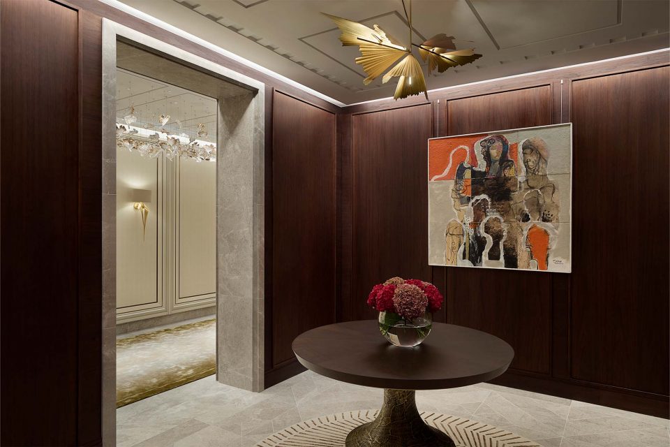 Elegant round centre table with a dark tinted oak top and a distressed bronze base - A Serene and Artisanal Luxury Home in Mayfair