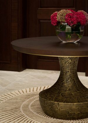 Elegant round centre table with a dark tinted oak top and a distressed bronze base - A Serene and Artisanal Luxury Home in Mayfair